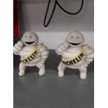 A pair of small reproduction Michelin men figures.