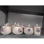 Eight Poole Pottery jam pots in the traditional pattern.