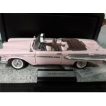 Three Franklin Mint precision models of cars.