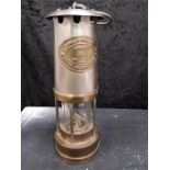 A brass miners lamp with glass funnel with Thomas & Williams Cambrian No BT.