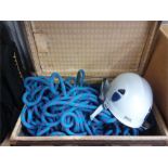 A suitcase of climbing rope and safety helmet.