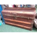 A domed top woodbound travel trunk.