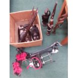 A box containing various African masks and figures together with rabbit ear bike rack and footpump.