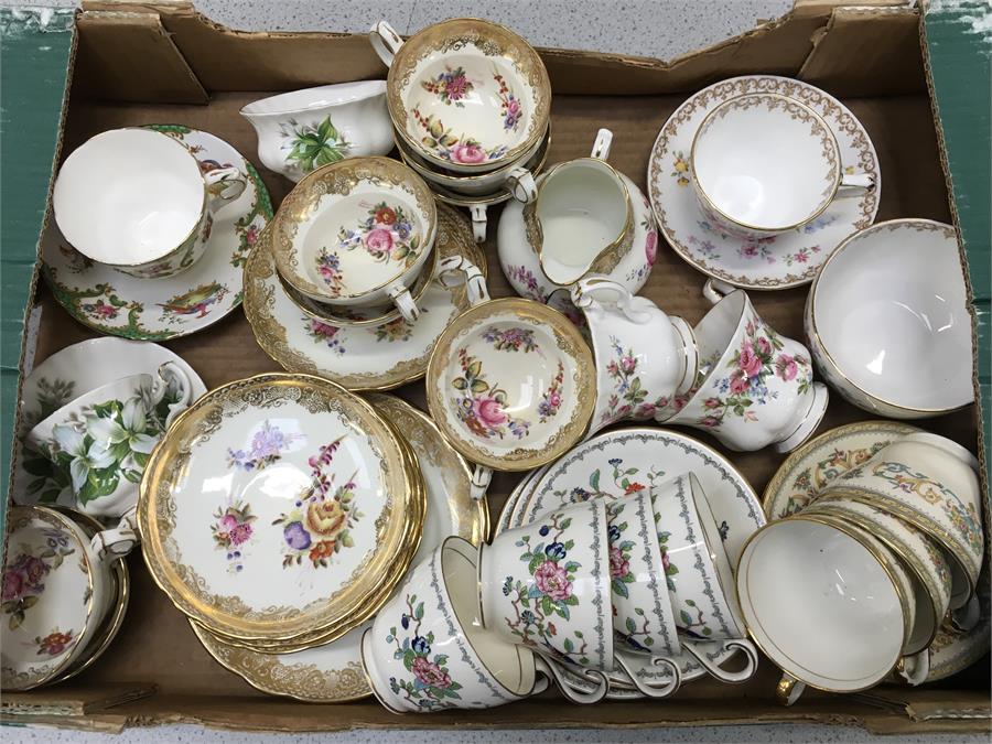 A box of china cups and saucers. Includes: Aynsley Pembroke and Henley, Royal Albert Trillium,