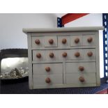 A miniature 14 drawer chest.