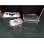 Three silver coloured cases, Logicline trunks and flight cases made in England.