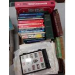 Two boxes containing stamp books and various others.
