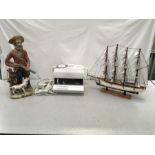 A Goblin Teasmade, a hunting figure and a model of the USS Cutter Eagle.