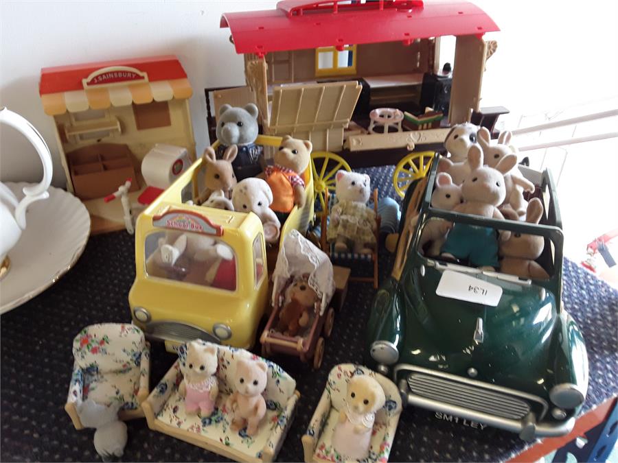 Sylvanian family items to include figures, a caravan, a shop and a car.