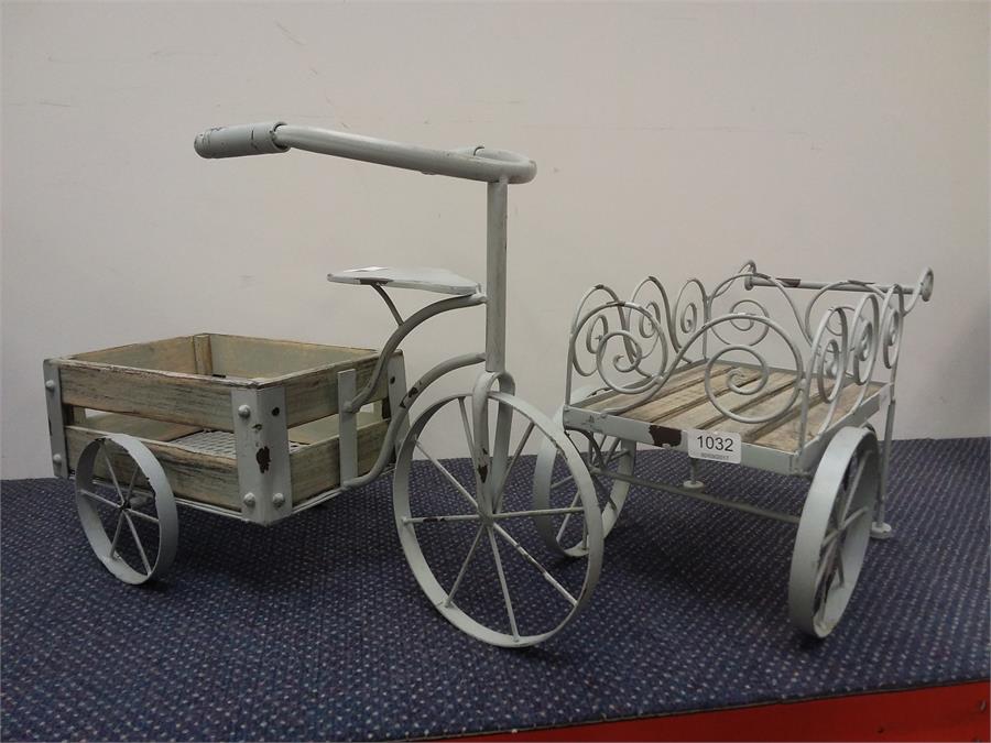 Two metal garden items depicting a bicycle with flower barrow.