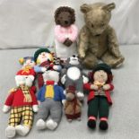 A collection of woollen characters including Rupert the bear and a teddy bear.