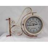 An exterior wall hanging clock.