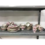 A large quantity of pink and floral paneled couple in garden design Dresden tea ware to consist of