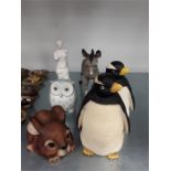 A selection of 6 ceramic collectables including a donkey, penguins, owl and rabbit.