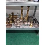 A collection of various pieces of brass antique candlesticks ,chamber stick , egg cruet and silver