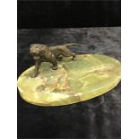 A bronzed figure of a tiger on onyx pin tray base.