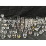 A large collection of whisky glasses, with a decanter and ice bucket.