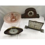 Three vintage clocks together with a rose glass bowl and female figure.