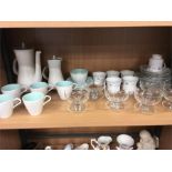 A blue and white coffee set by Poole Pottery, with glass dessert bowls and other china.