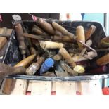 A bucket of vintage chisels and hand tools.