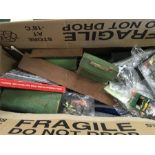 A box of assorted model railway scenery.