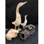 A modern wooden duck with another together with a wooden sculpture of a frog on a mushroom and a