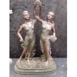 A resin figurine of two maidens.