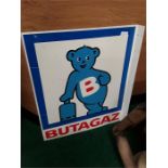 A metal blue and red 'Butagaz' advertising sign.