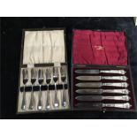 A boxed set of six dessert knives and a set of plated cake forks.