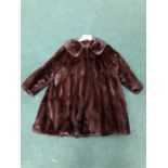 A vintage ladies brown fur coat.