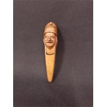 A treen Nutcracker. designed as a mans face and wearing a hat