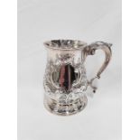 A Georgian silver tankard chased in the Rococo style with scroll handle London 1754. (779 grams).