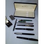 A small quantity of pens in case to include green effect ,1950s design and 4 flickem lighters