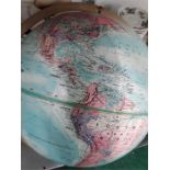 A Replogle 12" diameter world globe printed various colours on metal base.