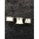 Three silver napkin rings and a silver pickle spoon (85 grams).