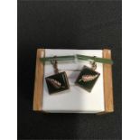 A pair of 9ct gold and jade cuff links