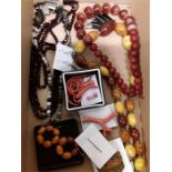 A box of vintage stone set jewellery including Amber, coral. Banded agate, garners and unusual "