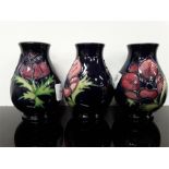 Three Moorcroft baluster shaped vases (4") high in the anemone pattern.