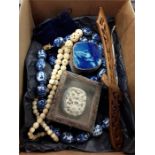 A box of three antique carved ivory items, a string of Chinese blue and white hand made beads with