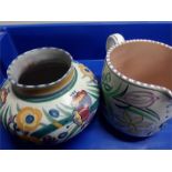 Two pieces of traditional Poole Pottery a floral painted jug and a vase