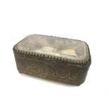 A Victorian bevelled glass topped brass jewellery box with cushion padding.