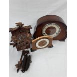 Two mantle clocks together with a small cuckoo clock.