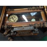 An oak cased vienesse wall hanging chiming clock with key and wooden decorations.