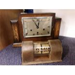 A wooden mantle clock together with another item.