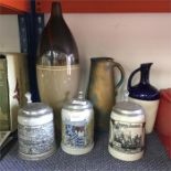 A collection of steins and vases.
