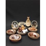 A collection of miniature ceramic animals displayed in ceramic baskets.