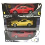 Three Hot Wheels 1/18 scale cars: 2 x Ferrari; Aston Martin V8 Vantage. Appear M and boxed.