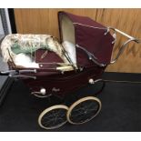 Royale twin doll's pram in burgundy c.1950's. Height 97cm, length 105cm approx. Overall G.