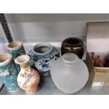 Oriental vases, Poole pottery and wooden carvings.