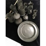 A collection of pewter including tapit hen. tankards. and early plates.